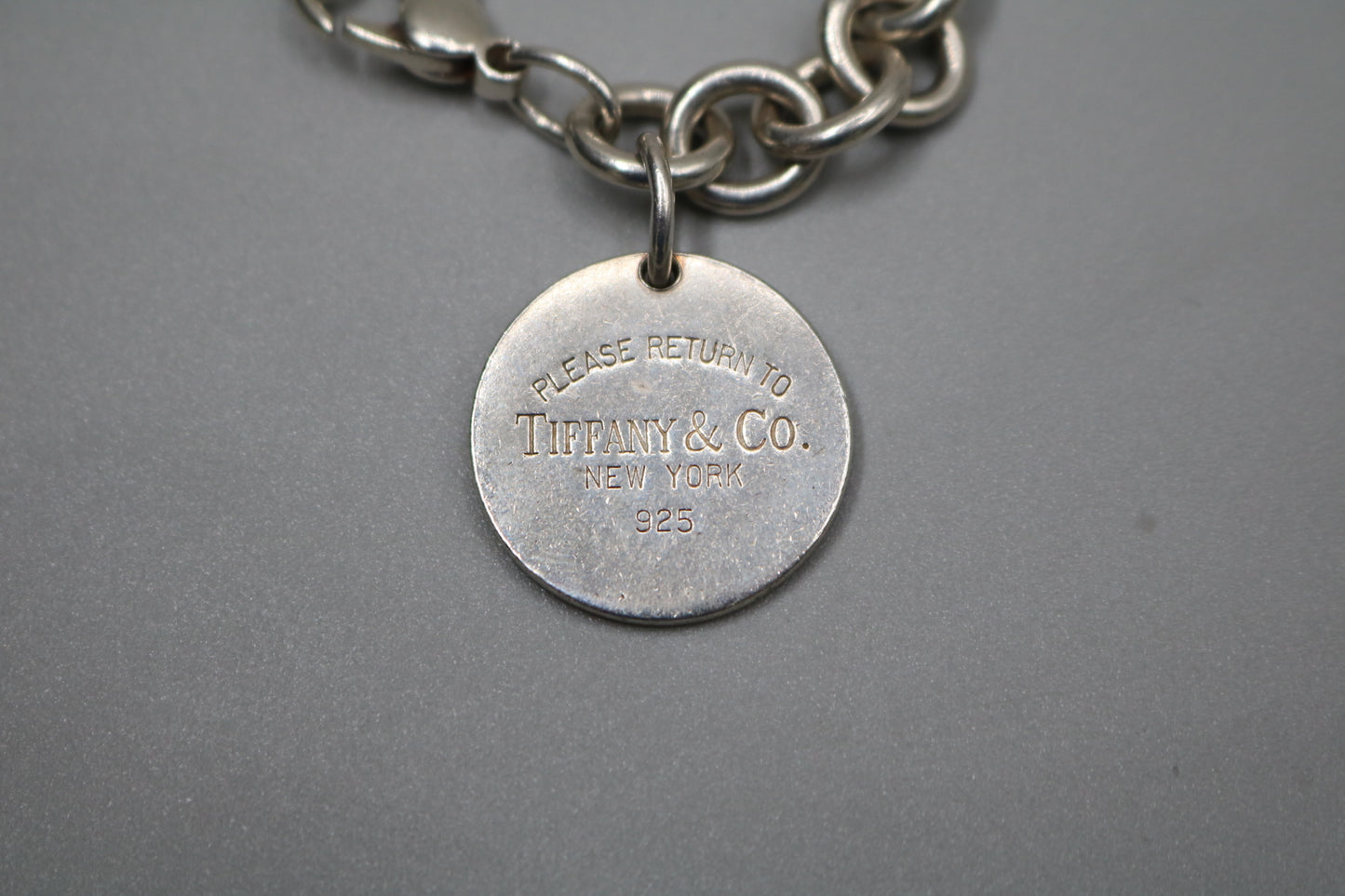 Tiffany & Co. Please Return To Tiffany & Co Round Charm Sterling Silver Bracelet (7.5 Inches)